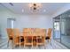 Bright dining room with large wood table and six chairs at 1802 E Hamilton Ave, Tampa, FL 33610