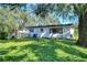 Side view of a ranch home with a large backyard at 1802 E Hamilton Ave, Tampa, FL 33610