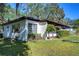 Ranch style home with white exterior and brown accents at 1802 E Hamilton Ave, Tampa, FL 33610