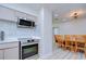 Modern kitchen with stainless steel appliances and dining area at 1802 E Hamilton Ave, Tampa, FL 33610