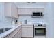 Modern kitchen with stainless steel appliances and light-colored cabinets at 1802 E Hamilton Ave, Tampa, FL 33610