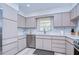 Modern kitchen with stainless steel appliances and light-colored cabinets at 1802 E Hamilton Ave, Tampa, FL 33610
