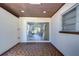 Covered patio with sliding glass doors and tiled floor at 1802 E Hamilton Ave, Tampa, FL 33610