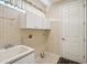 Convenient laundry room with cabinets and sink at 5544 Legend Hills Ln, Spring Hill, FL 34609