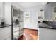 Stainless steel refrigerator, granite countertops, and wood floors create a modern kitchen space at 2210 4Th N Ave, St Petersburg, FL 33713