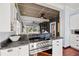 Open kitchen with stainless steel appliances and granite countertops leads to dining and living areas at 2210 4Th N Ave, St Petersburg, FL 33713