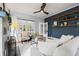 Comfortable living room with large window and dark accent wall with floating shelves at 2210 4Th N Ave, St Petersburg, FL 33713