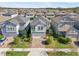 Two-story house, gray roof, light gray siding, and brick driveway, aerial view at 9612 Little Bluestem Dr, Land O Lakes, FL 34637