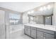 Main bathroom with double vanity, soaking tub and shower at 9612 Little Bluestem Dr, Land O Lakes, FL 34637