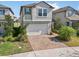 Two-story house with a green facade, brick driveway and landscaped yard at 9612 Little Bluestem Dr, Land O Lakes, FL 34637