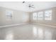 Spacious living room with tile floors and large windows at 9612 Little Bluestem Dr, Land O Lakes, FL 34637