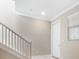 Modern staircase with white railings leading to the second floor at 9612 Little Bluestem Dr, Land O Lakes, FL 34637