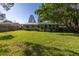 House's back exterior and expansive lawn at 1960 Alton Dr, Clearwater, FL 33763