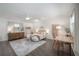 Bright bedroom with a ceiling fan, neutral-colored bedding, and dark wood-look floors at 6701 N Branch Ave, Tampa, FL 33604