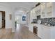 Bright hallway with hardwood floors and archways leading to other rooms at 824 Manns Harbor Dr, Apollo Beach, FL 33572