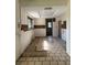 Kitchen with tiled floor and wood-paneled walls at 64 Inness Dr, Tarpon Springs, FL 34689