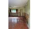 Living room with tile floors and window, needs renovation at 64 Inness Dr, Tarpon Springs, FL 34689