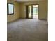 Living room with sliding doors to patio at 64 Inness Dr, Tarpon Springs, FL 34689