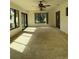 Spacious sunroom with tiled floors and windows at 64 Inness Dr, Tarpon Springs, FL 34689