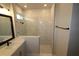 Bathroom with marble-look tile, glass shower, and modern vanity at 679 Allora Ave, Nokomis, FL 34275