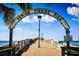 Venice Fishing Pier on a sunny day with couple walking at 679 Allora Ave, Nokomis, FL 34275