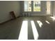 Bright living room with wood-look flooring and large windows at 679 Allora Ave, Nokomis, FL 34275