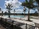 Community pool with lounge chairs and palm trees at 679 Allora Ave, Nokomis, FL 34275