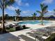 Community pool with lounge chairs and palm trees at 679 Allora Ave, Nokomis, FL 34275