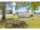 Landscaped backyard with a charming patio set at 1300 Cedar Ct, Tarpon Springs, FL 34689