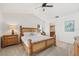 Main bedroom with wooden bed frame and ensuite bathroom access at 1300 Cedar Ct, Tarpon Springs, FL 34689