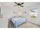Cozy bedroom with a queen-size bed and a window with backyard view at 1300 Cedar Ct, Tarpon Springs, FL 34689