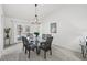 Dining room with glass table, six chairs, and a chandelier at 1300 Cedar Ct, Tarpon Springs, FL 34689