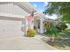 House exterior featuring a garage, walkway, and nicely landscaped yard at 1300 Cedar Ct, Tarpon Springs, FL 34689