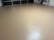 Tan epoxy garage floor with minor cracks at 1300 Cedar Ct, Tarpon Springs, FL 34689