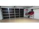 Two-car garage featuring an epoxy coated floor and storage shelving at 1300 Cedar Ct, Tarpon Springs, FL 34689