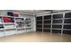 Spacious garage with epoxy floor and ample storage shelving at 1300 Cedar Ct, Tarpon Springs, FL 34689