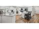 Updated kitchen with white cabinets, granite island and wood flooring at 1300 Cedar Ct, Tarpon Springs, FL 34689