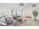 Living room with gray sofas, a coffee table, and a ceiling fan at 1300 Cedar Ct, Tarpon Springs, FL 34689