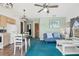 Open living area with teal carpet and sofa at 1300 Cedar Ct, Tarpon Springs, FL 34689