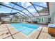 Screened pool and patio with seating at 1300 Cedar Ct, Tarpon Springs, FL 34689