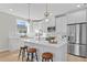 Modern kitchen with white cabinets, quartz countertops, and island seating at 208 W Frances Ave # 3, Tampa, FL 33602