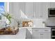 White kitchen with quartz countertops and stylish backsplash at 208 W Frances Ave # 3, Tampa, FL 33602