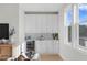 Modern wet bar with white cabinetry and wine cooler at 208 W Frances Ave # 3, Tampa, FL 33602