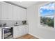Stylish wet bar featuring white cabinets and wine fridge at 208 W Frances Ave # 3, Tampa, FL 33602