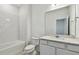 A clean bathroom with subway tile, a modern vanity, and a large mirror at 6765 Michael Favor Way, Wesley Chapel, FL 33545