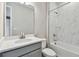 Bathroom features gray vanity, white quartz countertop, and marble-look tile at 2424 Wise River Ln, Zephyrhills, FL 33544