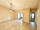 Neutral living room boasts tile flooring, a fan, and sliding glass doors to a covered outdoor area at 2288 Citrus Ct, Clearwater, FL 33763