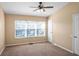 Well-lit bedroom featuring a large window and ceiling fan at 4517 Kennewick Pl, Riverview, FL 33578