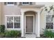 Tan two-story townhome with a brown door and landscaping at 4517 Kennewick Pl, Riverview, FL 33578