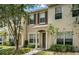 Attractive tan townhome with a tree and walkway at 4517 Kennewick Pl, Riverview, FL 33578